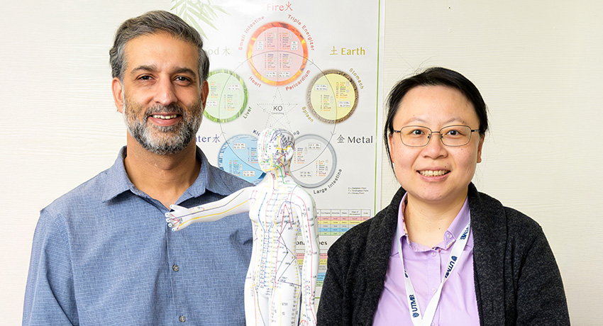 Photo of Hasan Yasin, MD and Wei-Chen Lee, PhD promoting the opening of the St. Vincent's Hope House Acupuncture Clinic in partnership with UTMB Health's Department of Family Medicine & Community Health & TAFP