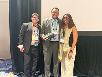Photo of Dr. Jose Rodriguez, Dr. Kendall M. Campbell and Dr. Judy Washington as they present Dr. Campbell an award at the 2026 STFM Annual Spring Meeting