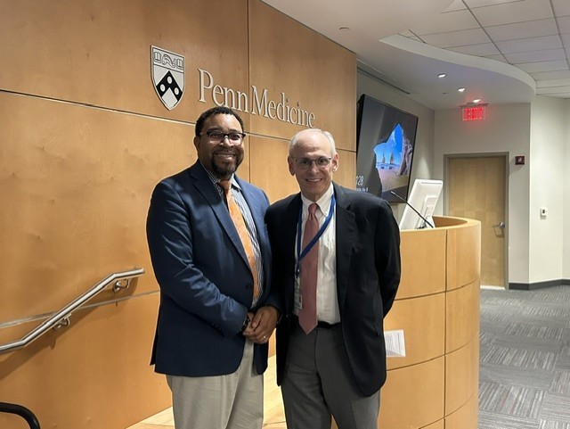 Photo of Kendall M. Campbell, Chair of UTMB Health's Family Medicine & Community Health giving a grand rounds lecture at the University of Pennsylvania. Also pictured is Chair of UPenn's department of Family Medicine and Community Health