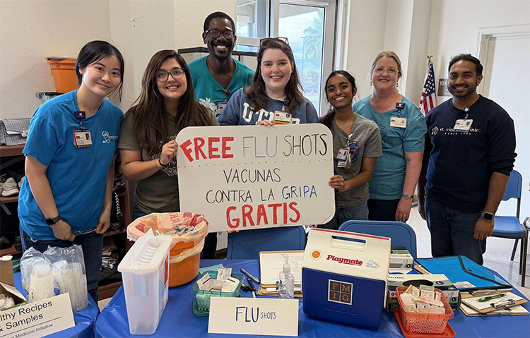 Photo of FMIG students and Dr. Jennifer Raley promoting Free Flu Shots for Galveston Residents