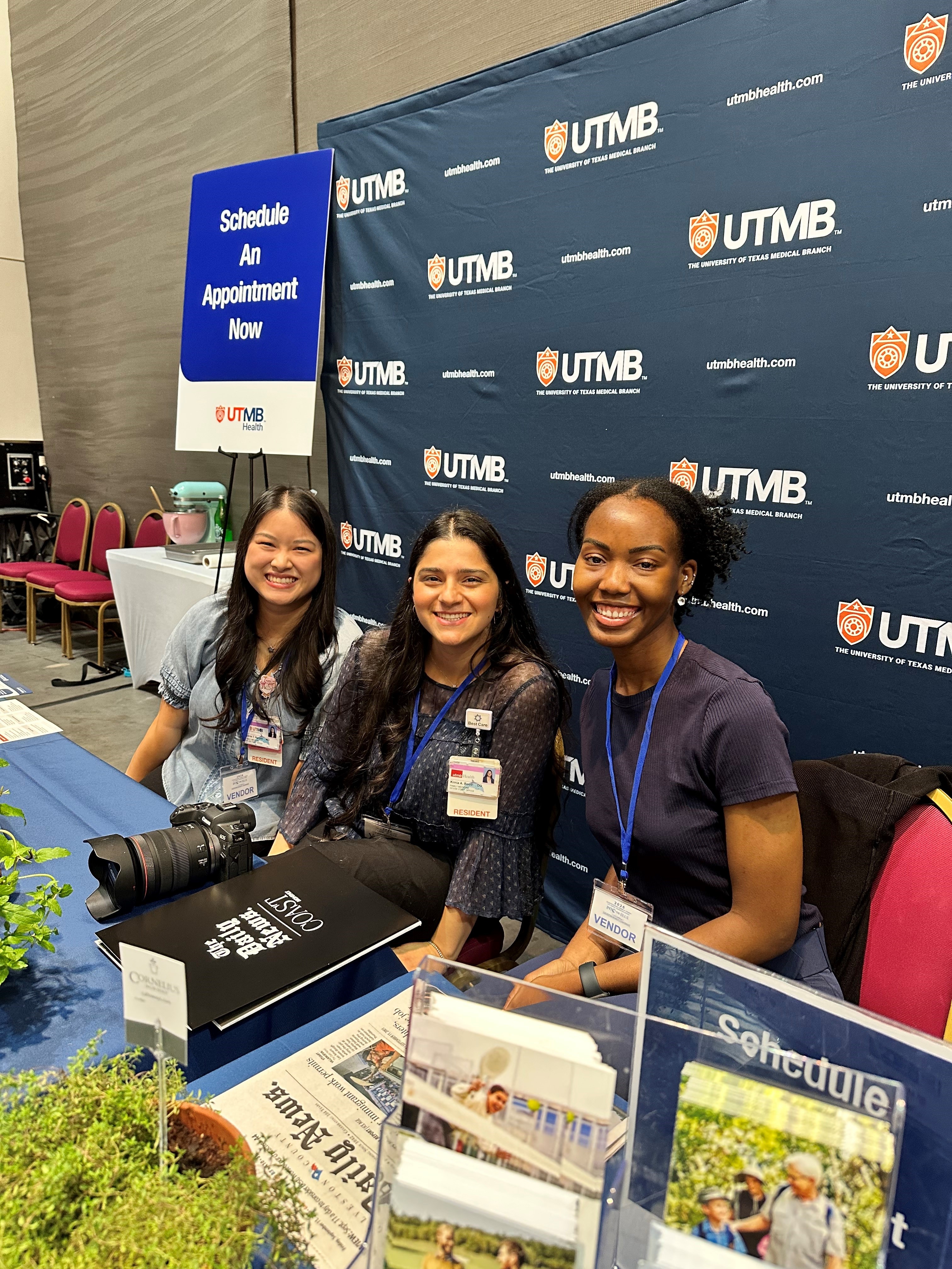 Photo of three residents manning booth at the Chamber Women's Conference