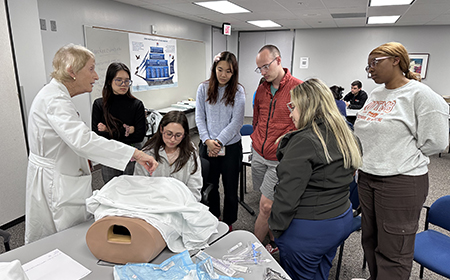 Faculty and Residents demonstrate women's health procedures to medical students