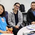 Small group of students seated together at a table with medical tools and supplies, participating in a hands-on clinical learning activity.