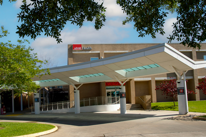 Exterior view of a UTMB Health building with a covered patient drop‑off entrance.