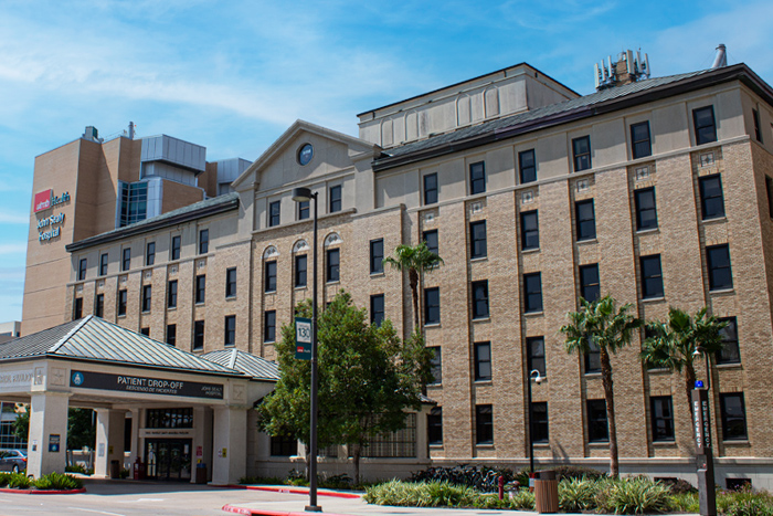 Exterior view of a UTMB Health building with a covered patient drop‑off entrance.