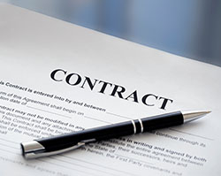 A printed document with the word "CONTACT" across the top with a ball point pen resting across it.
