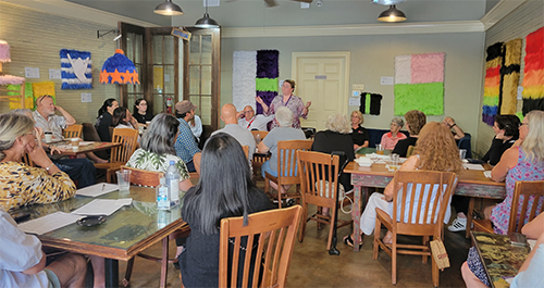 Stephanie Fitzgerald speaks to members of the public at Mod Coffeehouse in Galveston.