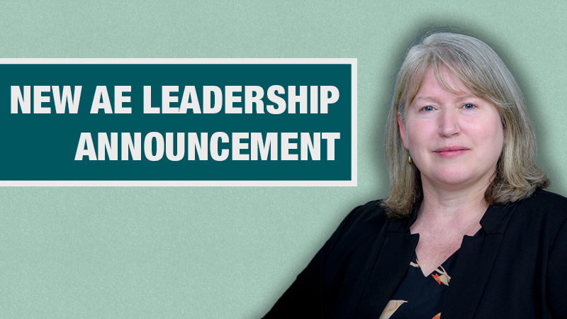 Graphic with a light teal background showing a person in a black cardigan beside a dark teal box containing the text ‘New AE Leadership Announcement.’