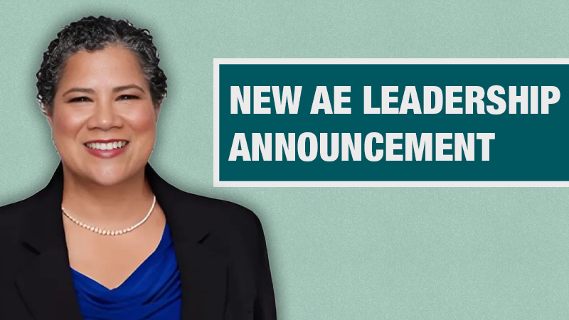 Graphic with a light teal background showing a person in a black blazer beside a dark teal box containing the text ‘New AE Leadership Announcement.’