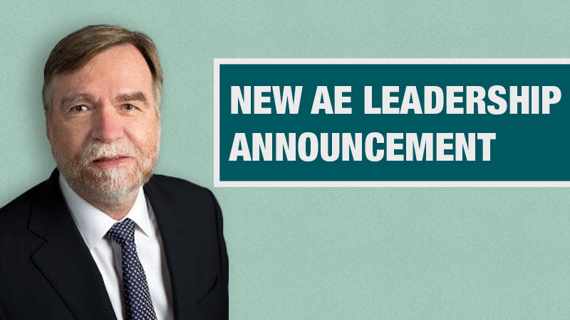 Graphic with a light teal background showing a person in a black blazer beside a dark teal box containing the text ‘New AE Leadership Announcement.’