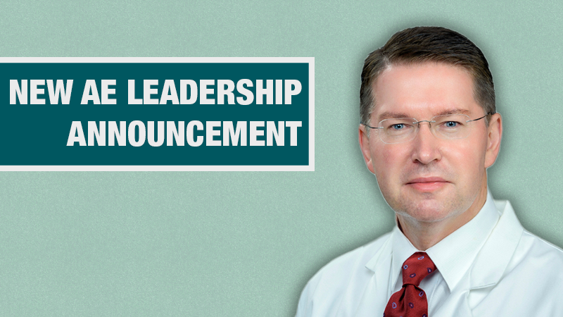 Graphic with a light teal background showing a person in a white lab coat beside a dark teal box containing the text ‘New AE Leadership Announcement.’