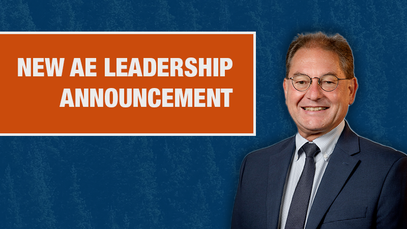 Graphic with a blue textured background showing a person in a navy blazer beside an orange box containing the text ‘New AE Leadership Announcement."