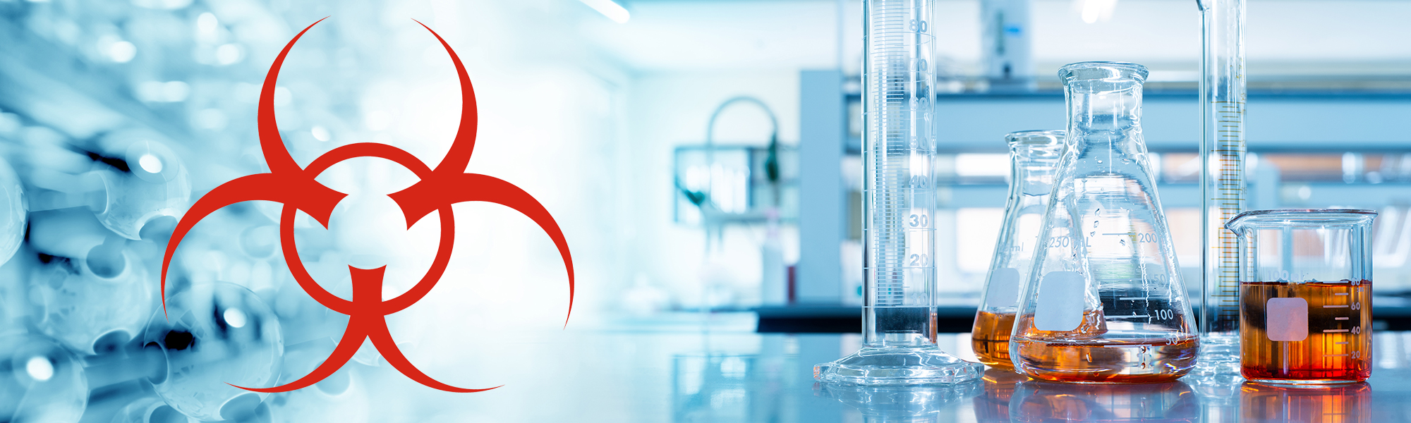 Laboratory glassware with amber liquid beside a red biohazard symbol in a clinical research lab setting.