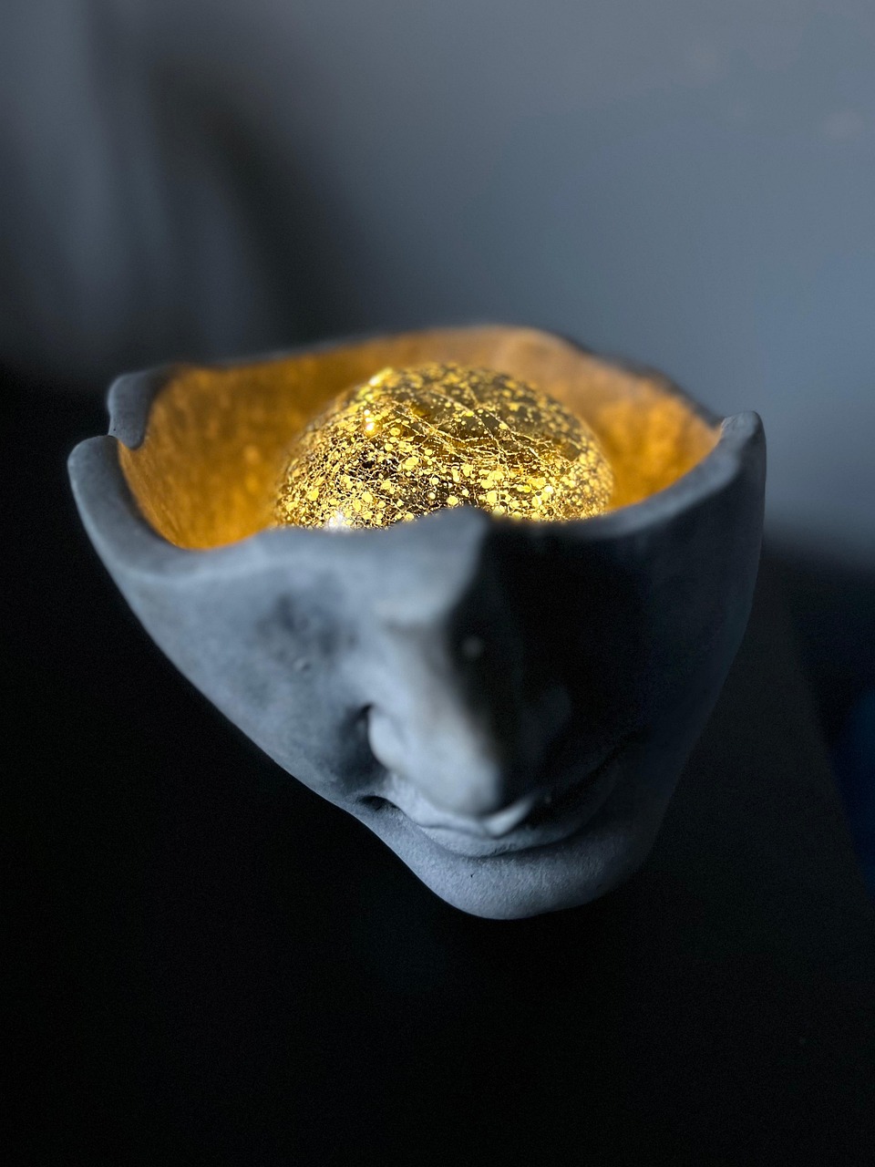 piece of gold inside a stone skull