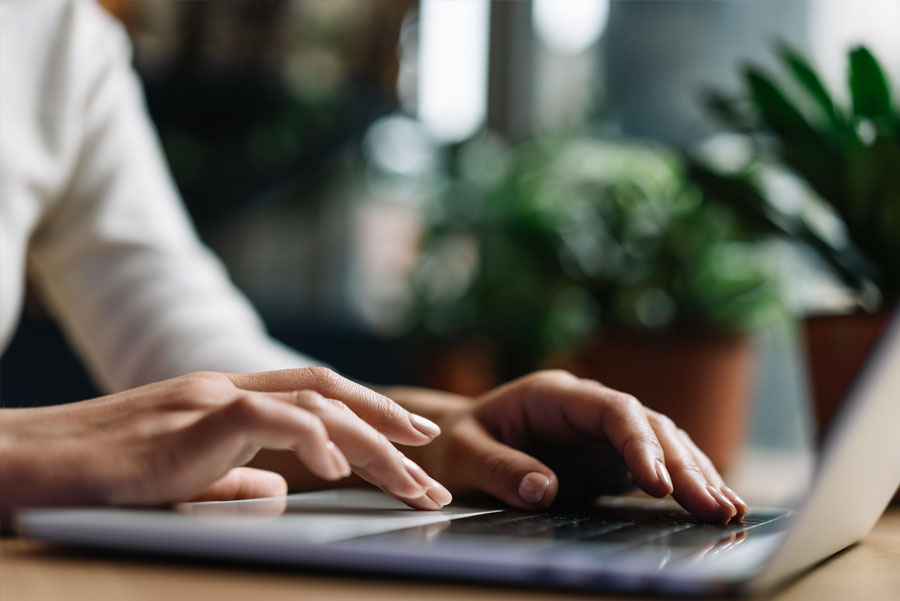 Closeup shot hands using laptop computer