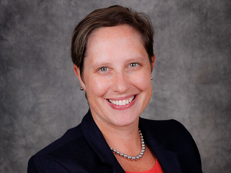 Professional portrait of Cora Rabe.