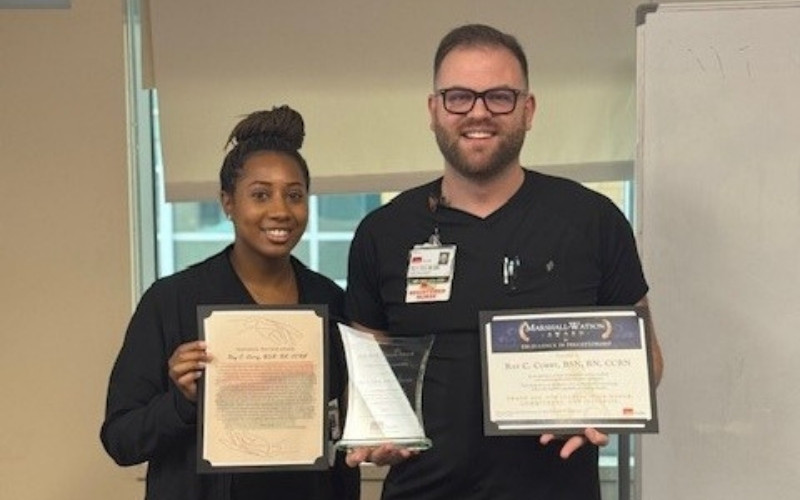 A Marshall-Watson Award recipient smiles and poses with his certificate and award, alongside the preceptee who nominated him.