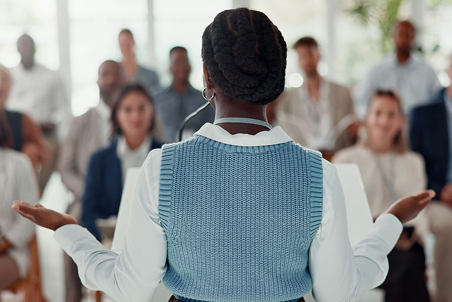 Woman facing a crowd at a public event