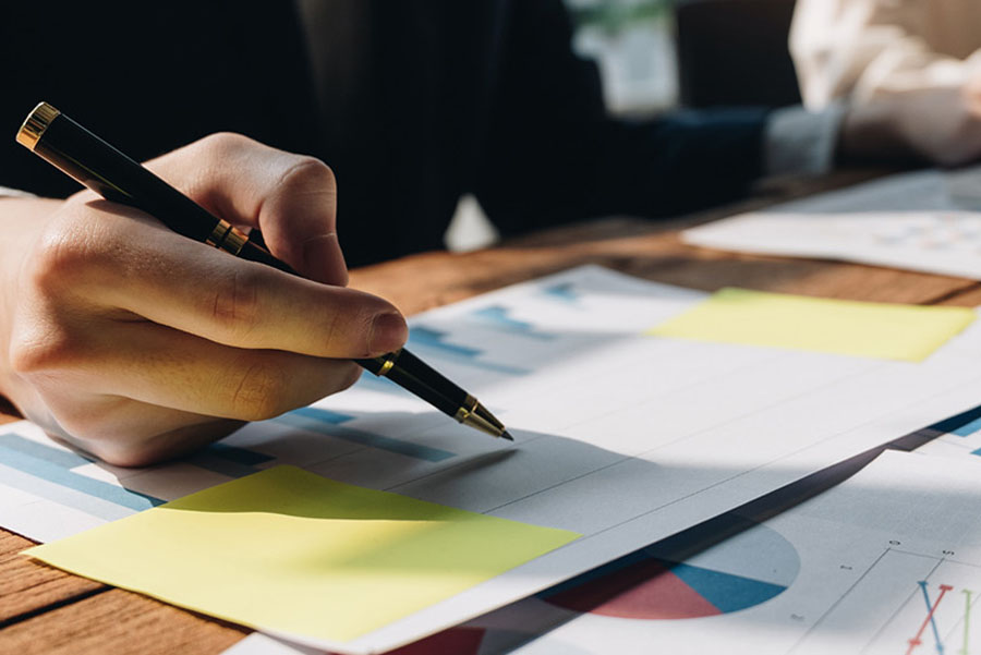 Marketing team reviewing printed graphs and data in the office
