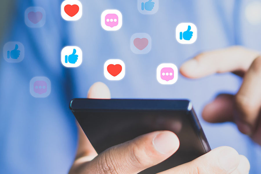Person using smartphone with floating social media icons like hearts and likes
