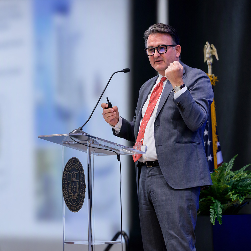 Dr. Reiser speaking at a podium