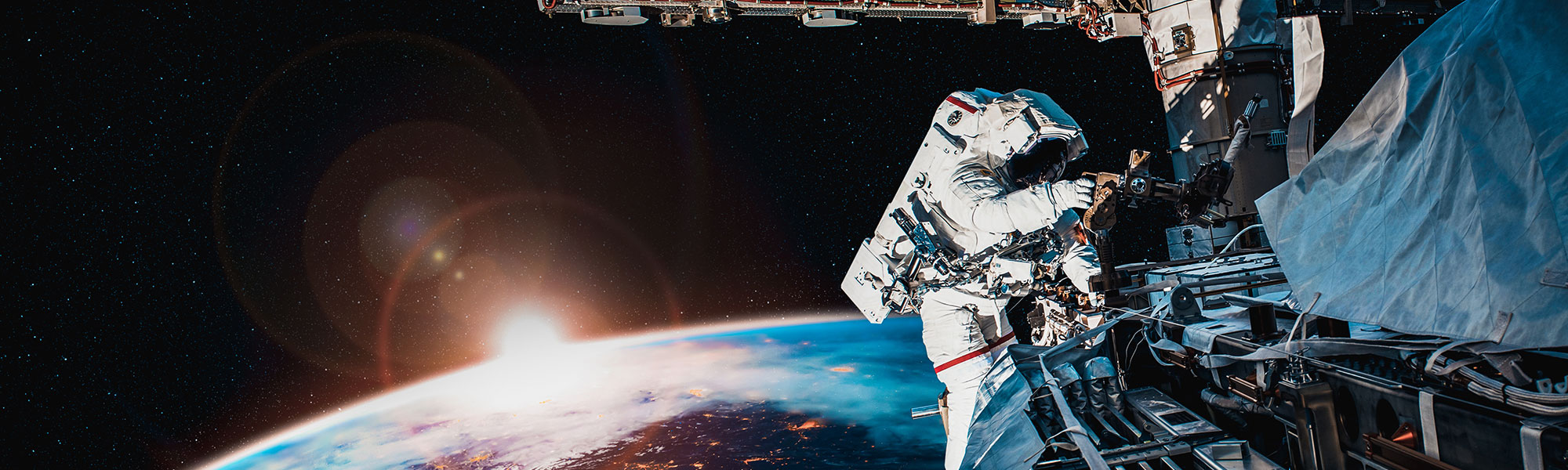 An astronaut wearing a space suit working on some equipment.