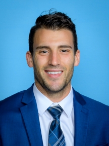 A professional headshot of Daniel Cox