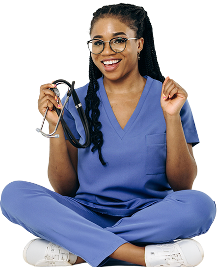 A woman wearing scrubs and a hold a stethoscope raising her hands with joy.