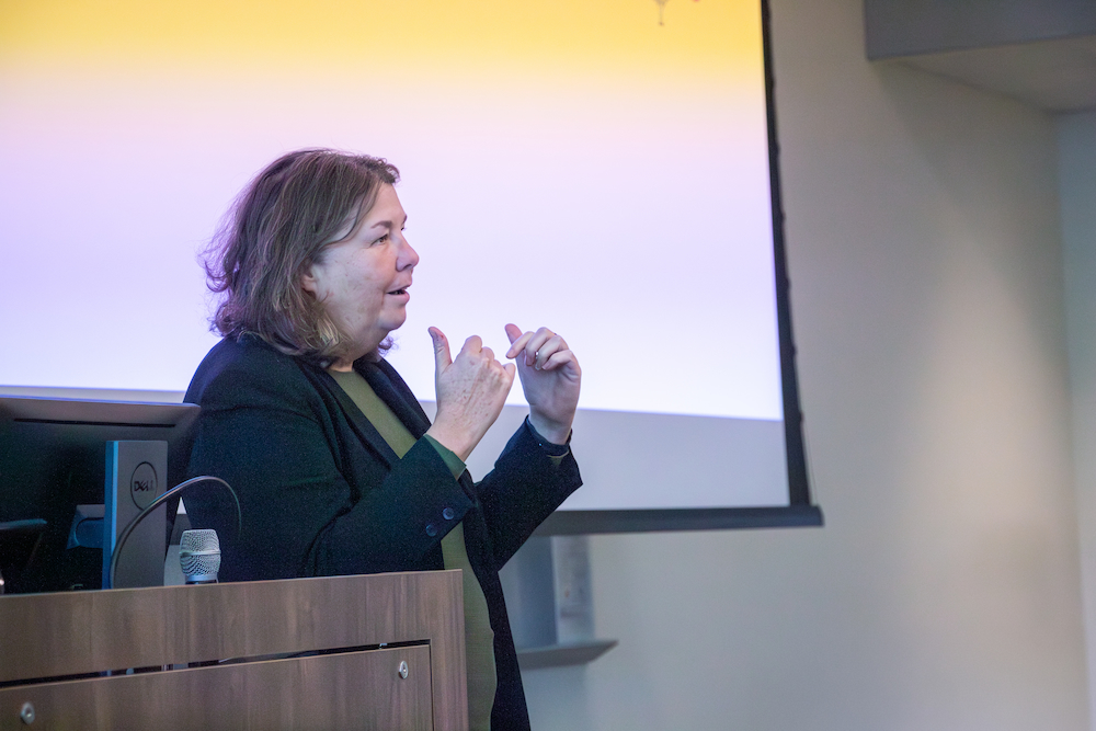 Leila Brammer stands by a podium during talk