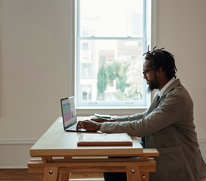 A man working on a laptop at a table