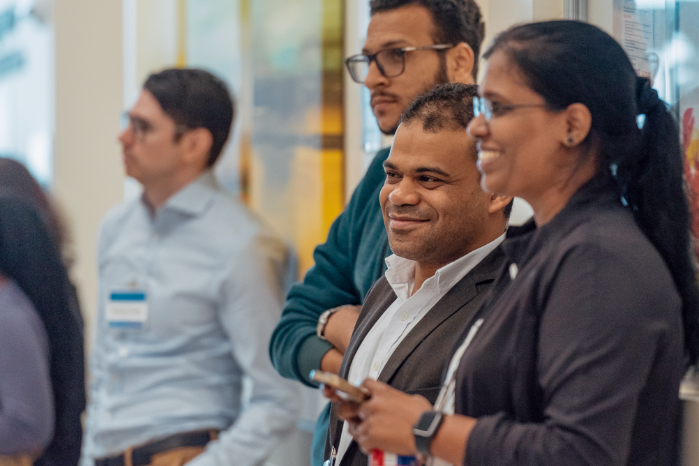 DSC_5191 Attendees stand together and talk during the poster session at the UTMB Public Health Symposium.
