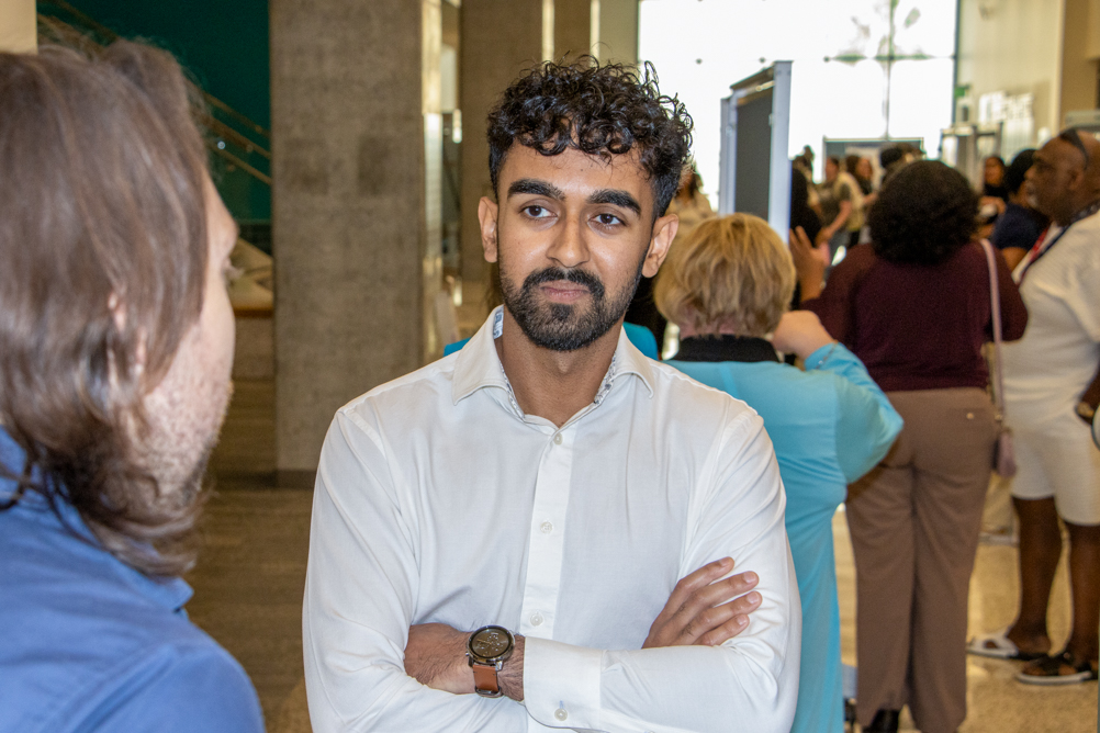 IMG_2920 A student speaks with another attendee during the poster session at the UTMB Public Health Symposium.