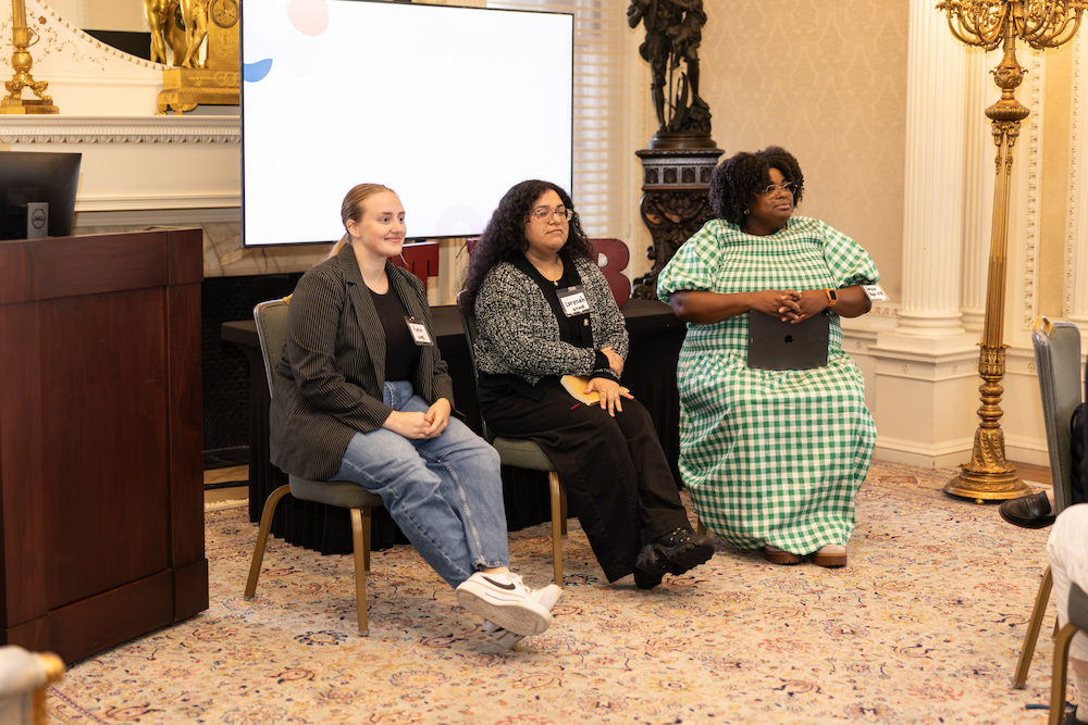 Three bioethics and health humanities students are seated as they take questions from the audience
