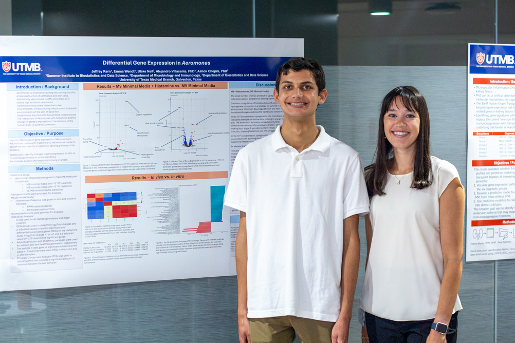 IMG_2805 Two SIBDS students stand beside a poster titled “Differential Gene Expression in Aeromonas.”