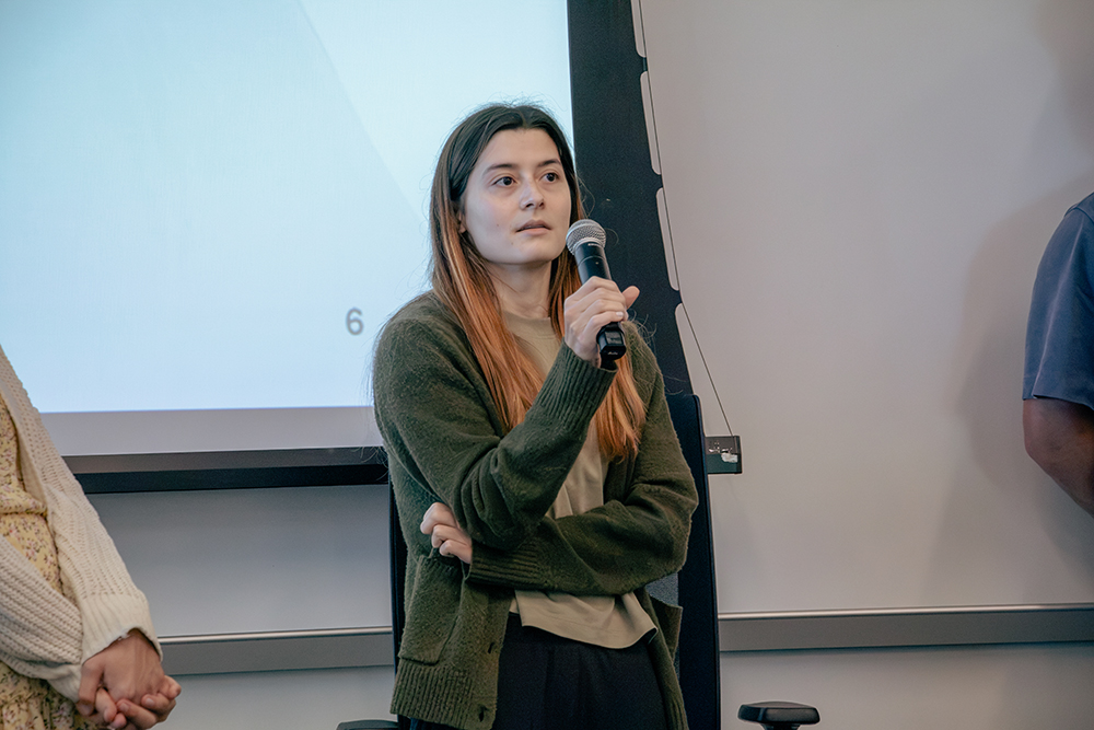 A member of Team ECHO takes a question from the judges during final presentations at the Clinical Informatics Datathon.