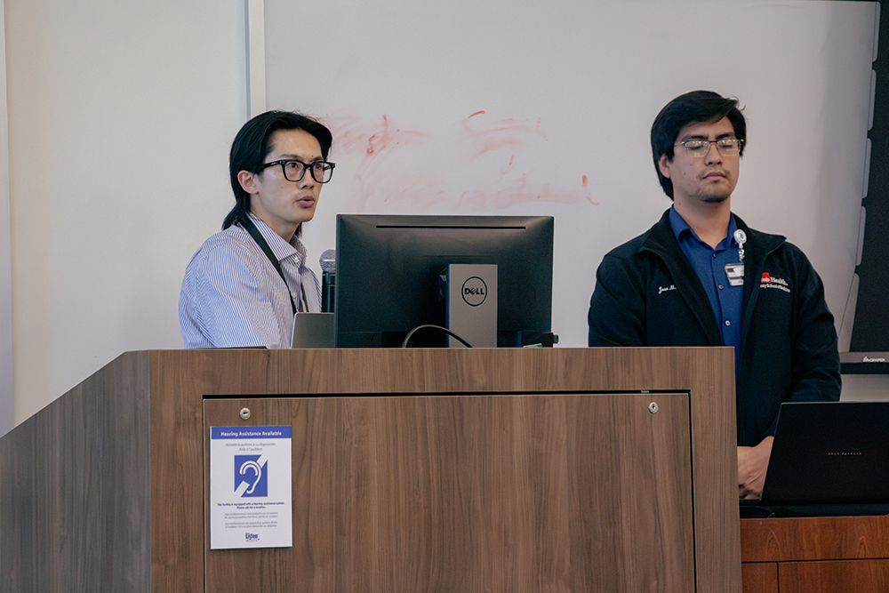IMG_3041 Jason Yeung and Jose M. Rojas present their analysis of anti-amyloid therapies and herpesvirus reactivation to the judging panel.