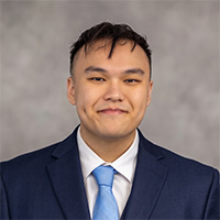Professional headshot of Alex Tan