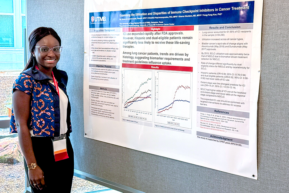 Rebecca Anumel-Ackah stands beside her research poster about disparities in the use of cancer immunotherapies.