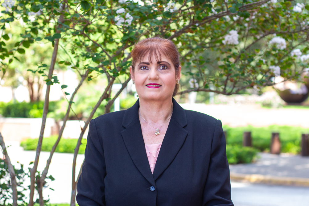 Professional headshot of Soham Al Snih, MD, PhD, against an outdoor background.