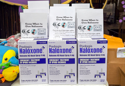 Boxes of narcan displayed on a table
