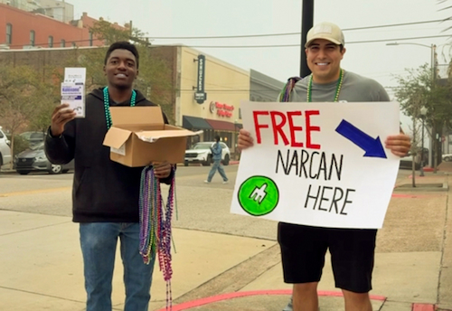 Students holding a sign that says 