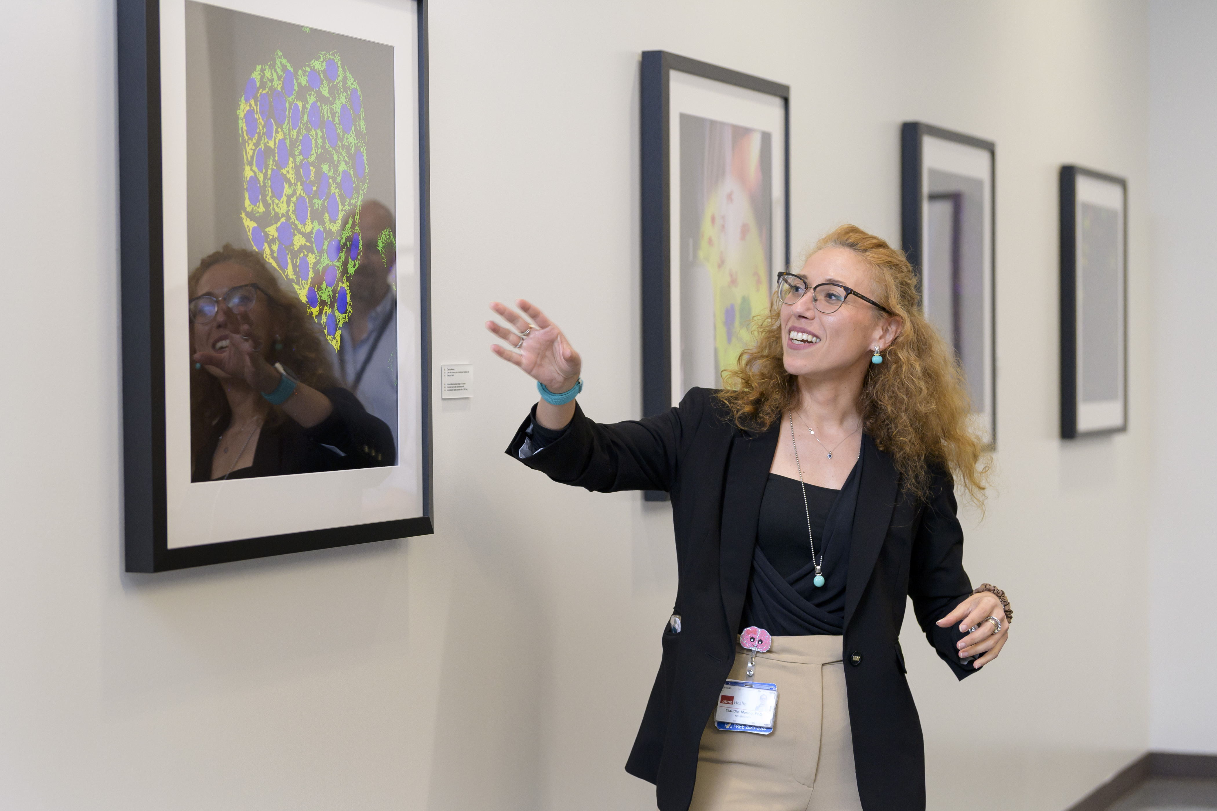 SIDD researcher presenting scientific imaging in a gallery hallway