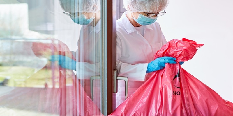 Healthcare worker disposing waste