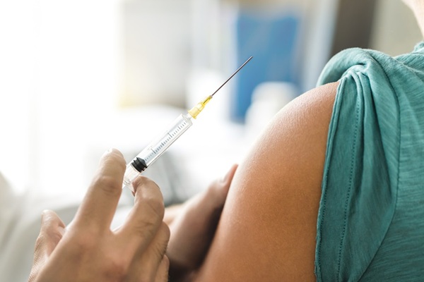 person administering vaccine