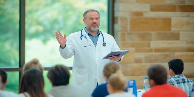 Healthcare professional talks to crowd