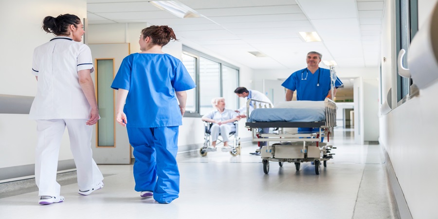 healthcare workers mingle in a hallway