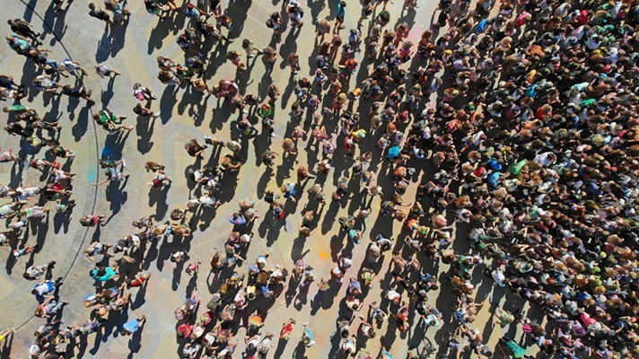 drone shot of large gathering of people at an event