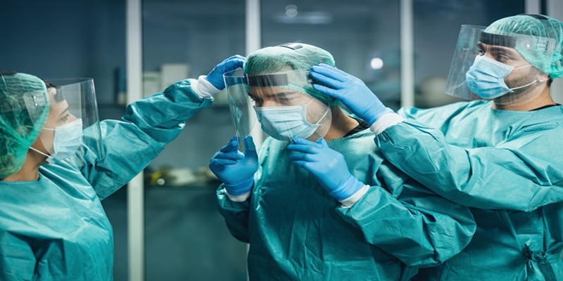 Group of healthcare workers donning PPE