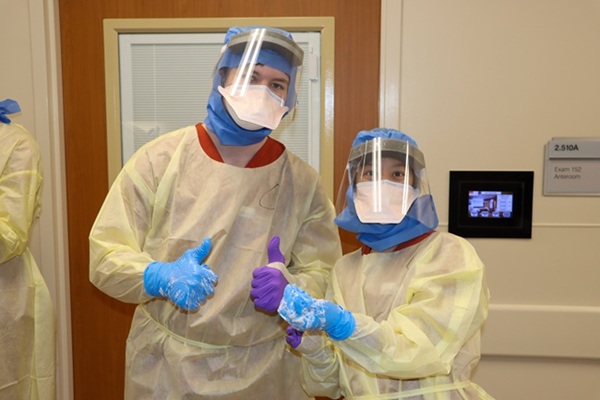 Nursing students pose with thumbs up