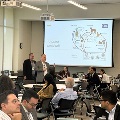conference attendees sit at round table discussion